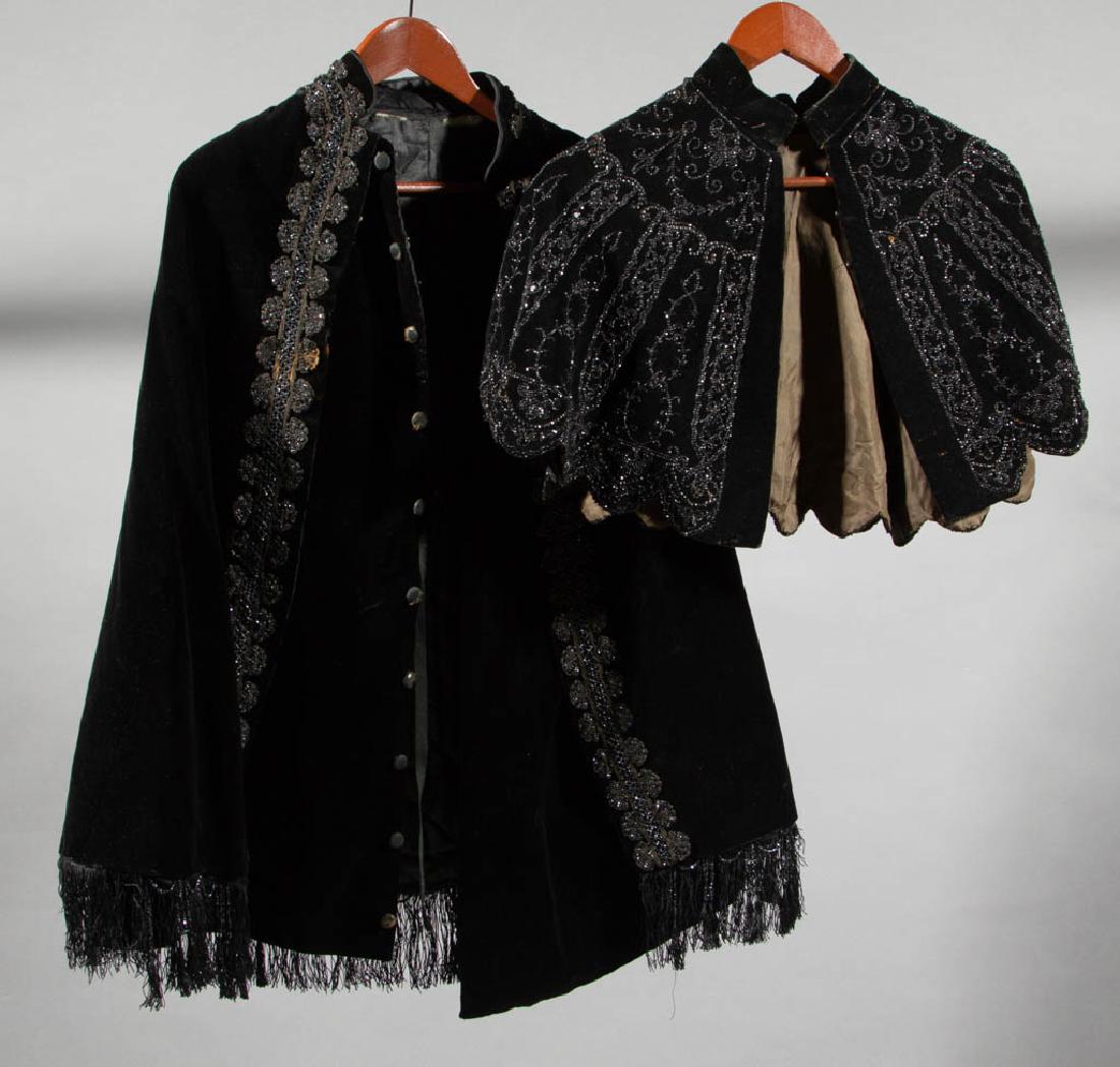ANTIQUE / VINTAGE BEAD-ACCENTED BLACK VELVET CAPES, LOT: ANTIQUE / VINTAGE BEAD-ACCENTED BLACK VELVET CAPES, LOT OF TWO, comprising a capelet example with overall beading and an interior department store label for Halle Bros. of Cleveland, Ohio, and a longe