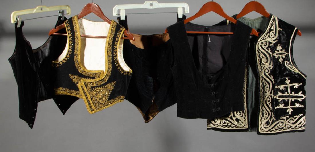 ASSORTED BLACK VELVET / VELVETEEN VESTS, LOT OF FIVE: ASSORTED BLACK VELVET / VELVETEEN VESTS, LOT OF FIVE, comprising three plain examples, an example with gold-toned filigree-type designs and trim, and an example with silver-toned detailing. 20th centu