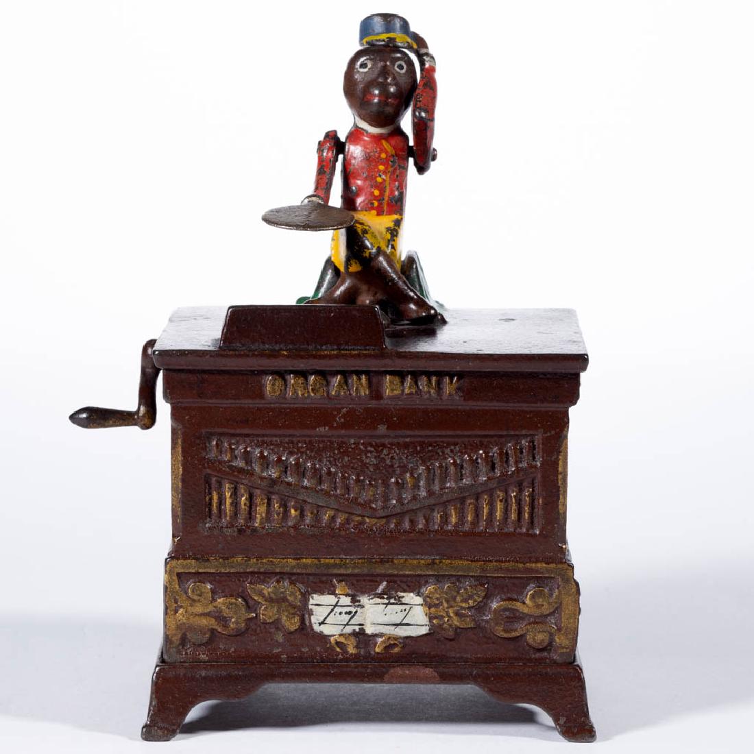 ORGAN BANK CAST-IRON MECHANICAL BANK: ORGAN BANK CAST-IRON MECHANICAL BANK, medium size with single figure, marked "116" to underside of base. Working condition (including bell) in original paint. Kyser & Rex, Frankford, PA. Circa 1890. 5