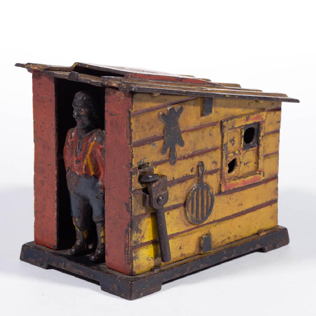 CABIN BANK CAST-IRON MECHANICAL BANK: CABIN BANK CAST-IRON MECHANICAL BANK, yellow version, designed by Edward L. Morris, marked "PATD JUNE 2D 1885" to underside of base. Working condition in original paint. J & E Stevens Co., Cromwell, C