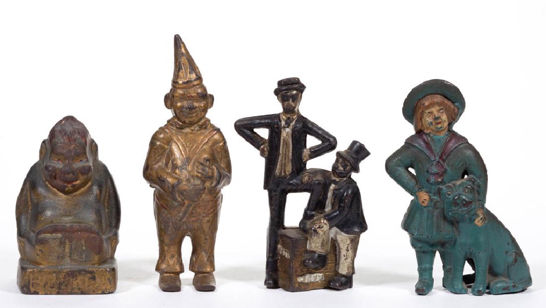 ASSORTED FIGURAL CAST-IRON PENNY / STILL BANKS, LOT OF: ASSORTED FIGURAL CAST-IRON PENNY / STILL BANKS, LOT OF FOUR, comprising a Mutt and Jeff, Clown, Billiken, and a Buster Brown and Tige. Each in original paint. A. C. Williams Co., Ravenna, OH. First qu