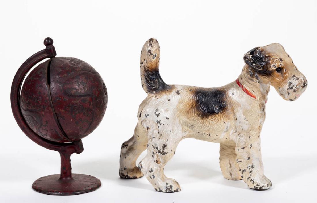 FIGURAL CAST-IRON ARTICLES, LOT OF TWO: FIGURAL CAST-IRON ARTICLES, LOT OF TWO, comprising a Globe on Arc penny / still bank by Grey Iron and a small-size, full-figure Terrier doorstop by Hubley. Each in original paint. Grey Iron Casting Co