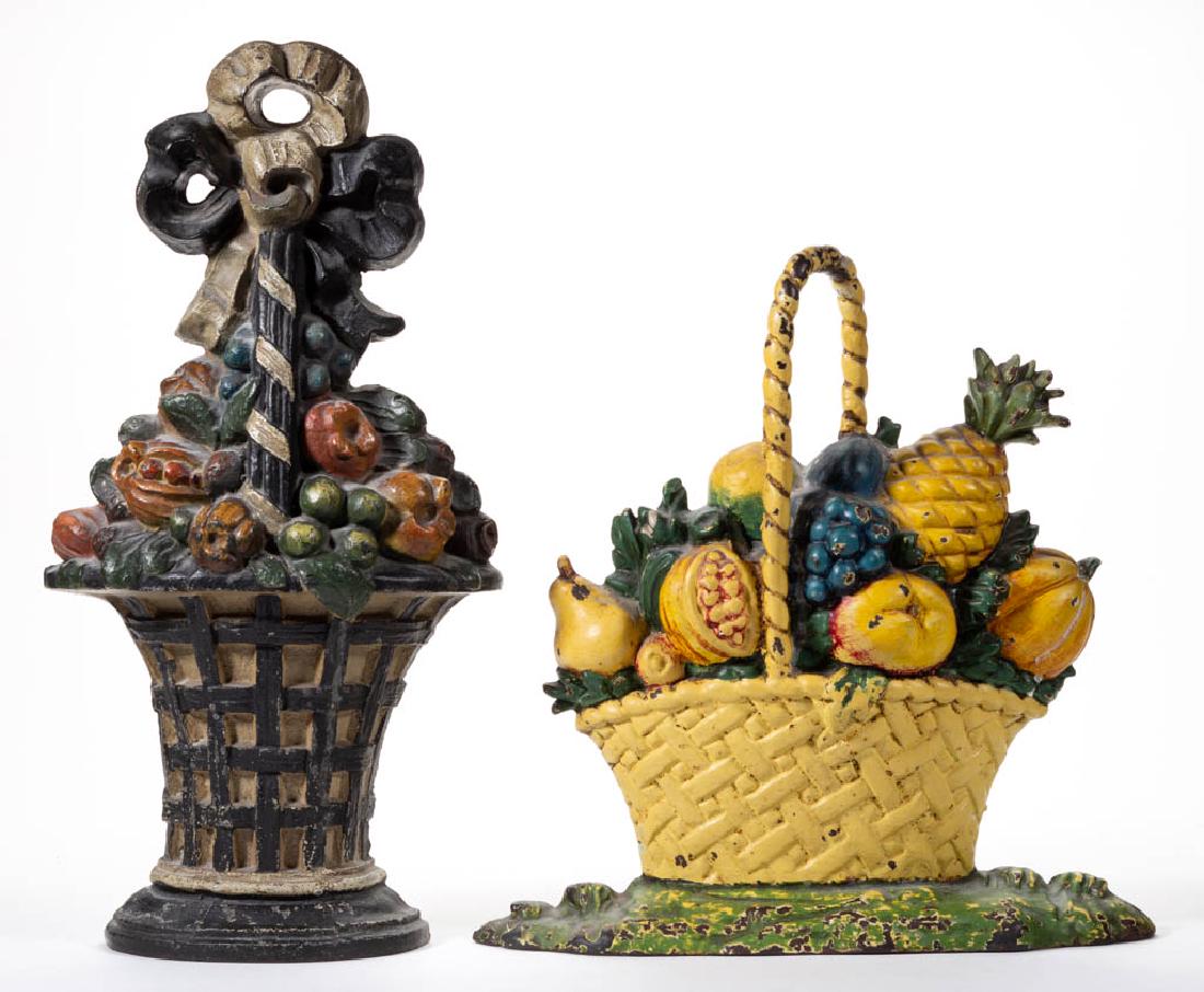 CAST-IRON FIGURAL DOORSTOPS, LOT OF TWO: CAST-IRON FIGURAL DOORSTOPS, LOT OF TWO, comprising a Fruit Basket with original paint, old tag for "HOOPS FIREPLACE / CHICAGO" attached to reverse, and a Large Fruit with Wicker Basket with later sur