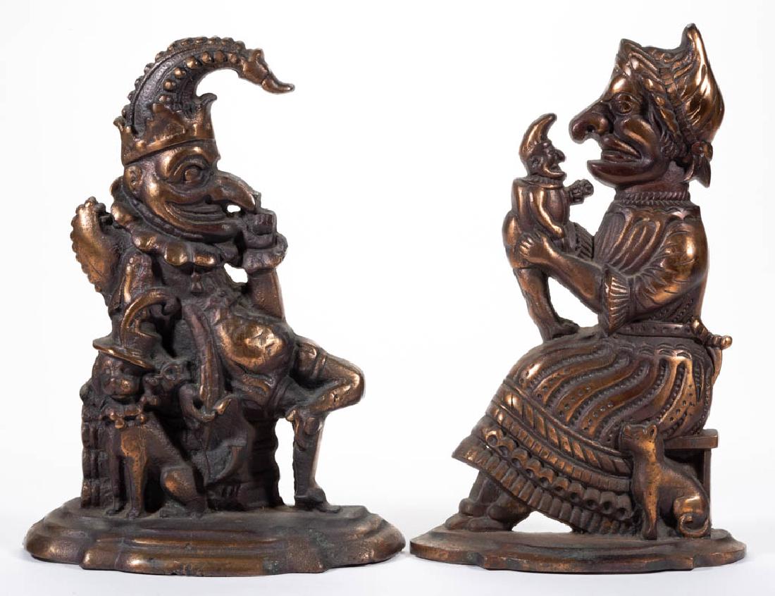 PAIR OF PUNCH AND JUDY FIGURAL CAST-IRON DOORSTOPS: PAIR OF PUNCH AND JUDY FIGURAL CAST-IRON DOORSTOPS, each flat-back, hollow form with original bronze / copper finish. First half 20th century. 11 7/8" and 12 1/4" HOA.Each in very good overall conditi