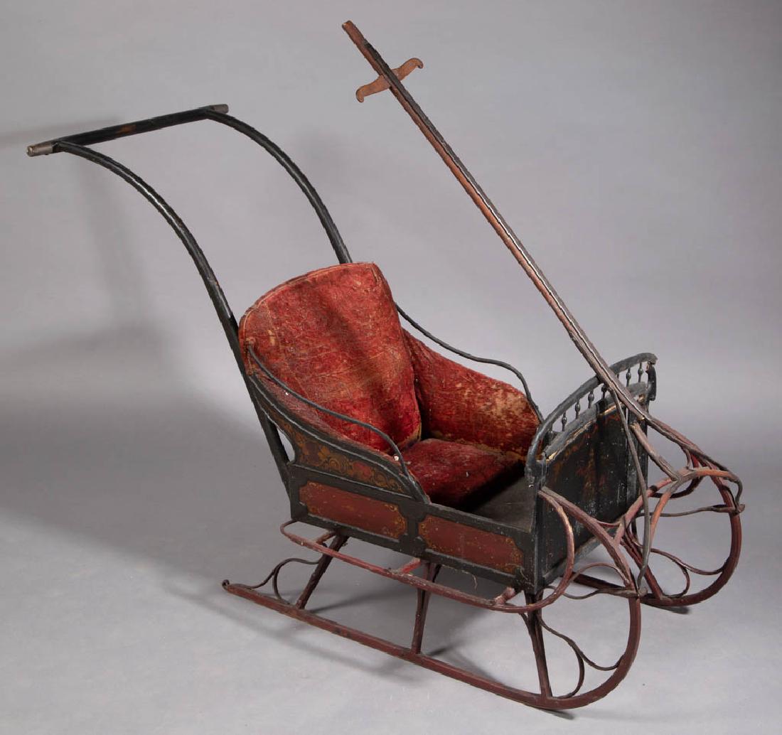 VICTORIAN PAINT-DECORATED CHILD'S PUSH SLED: VICTORIAN PAINT-DECORATED CHILD'S PUSH SLED, oak frame and handle with iron runners and supports. Original paint with stenciled decoration and upholstery. Fourth quarter 19th/early 20th century. 33 1/