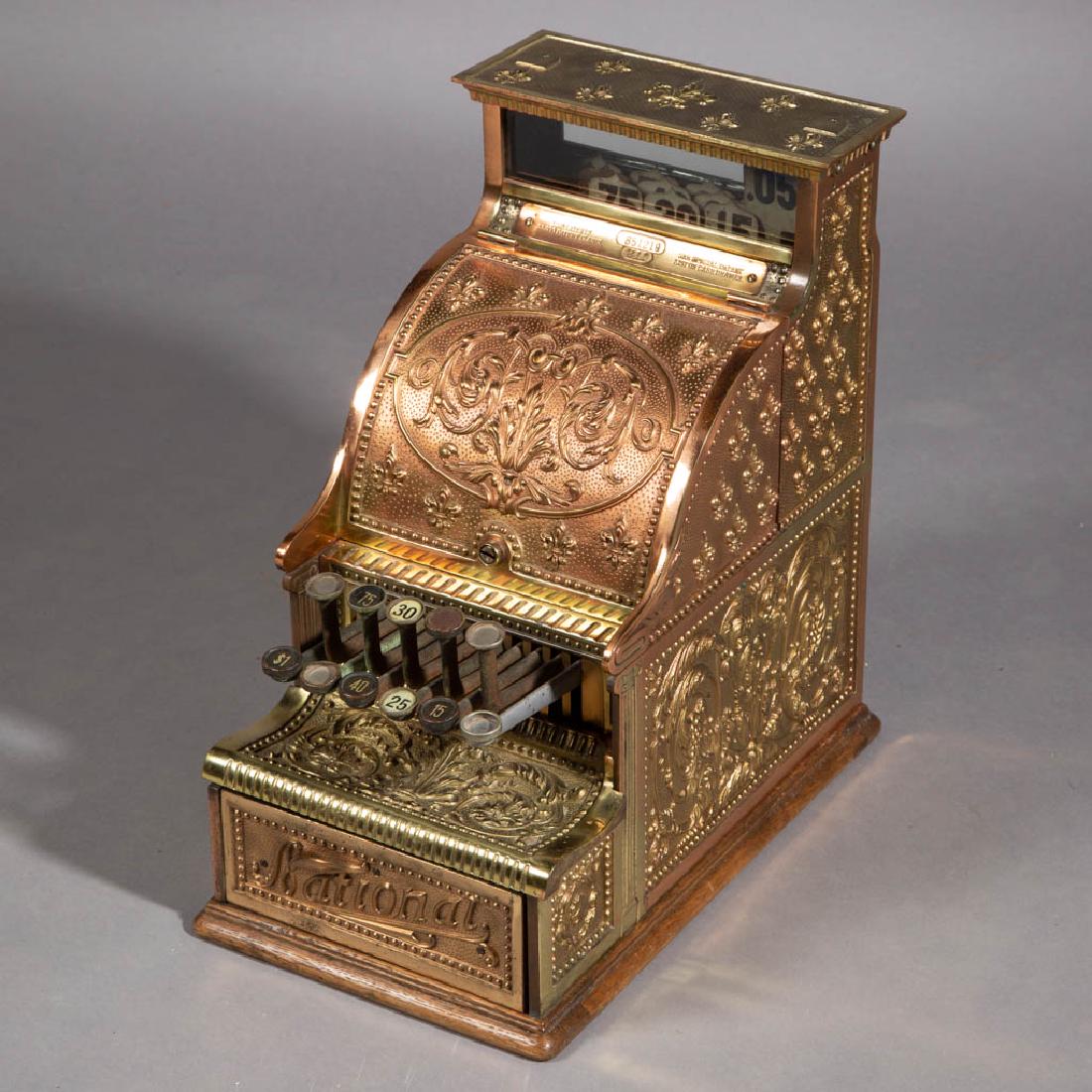 BRASS NATIONAL CANDY STORE MODEL 211 CASH REGISTER: BRASS NATIONAL CANDY STORE MODEL 211 CASH REGISTER, 11 keys, marked with serial number "651219" and additional patent information, body bearing Fleur de Lys design with copper finish and gold detail, 