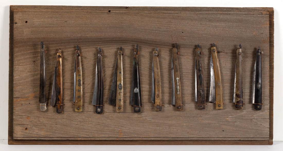ASSORTED ENGLISH HORN-HANDLED STRAIGHT RAZORS, LOT OF: ASSORTED ENGLISH HORN-HANDLED STRAIGHT RAZORS, LOT OF 12, including one pressed-horn example, and five with escutcheon plates, all displayed on a wooden panel. Late 18th/first quarter 19th century. 5 