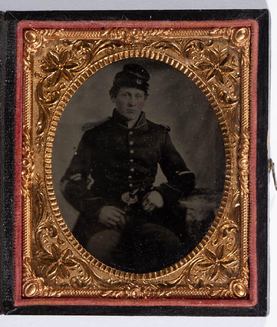 UNION CIVIL WAR SOLDIER AMBROTYPE PHOTOGRAPHIC IMAGE: UNION CIVIL WAR SOLDIER AMBROTYPE PHOTOGRAPHIC IMAGE, sixth-plate, depicting a seated soldier in full uniform with pistol in belt. House in an embossed leather-covered case. 1861-1865. 3 1/4" x 2 3/4"
