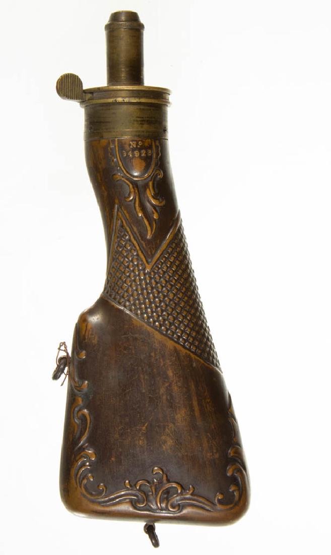 ENGLISH BRASS GUN STOCK POWDER FLASK: ENGLISH BRASS GUN STOCK POWDER FLASK, stamped "Improved Patent James Dixon & Sons Sheffield", with embossed decoration and "No 94923" and on the reverse a hallmark. First half 19th century. 7 3/4" LOA