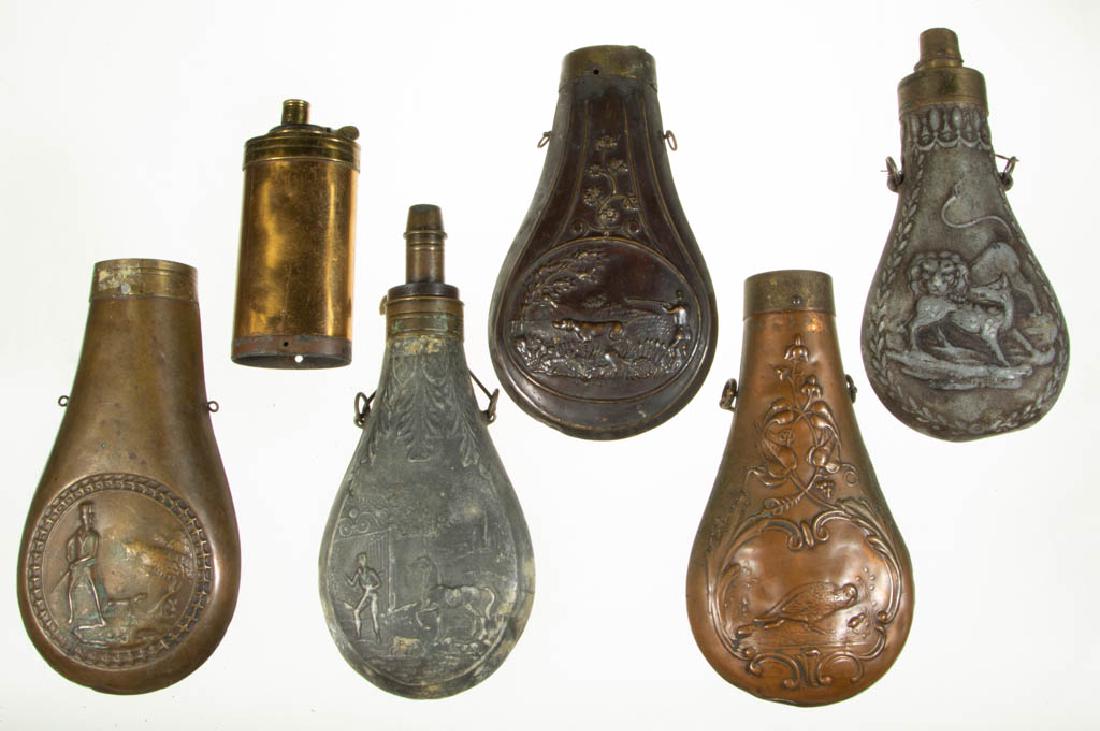 ASSORTED COPPER AND BRASS POWDER FLASKS, LOT OF SIX: ASSORTED COPPER AND BRASS POWDER FLASKS, LOT OF SIX, pewter examples with embossed decoration of a man and horse, and lion fighting a wolf, copper examples with two hunting scenes and pheasants. 19th 