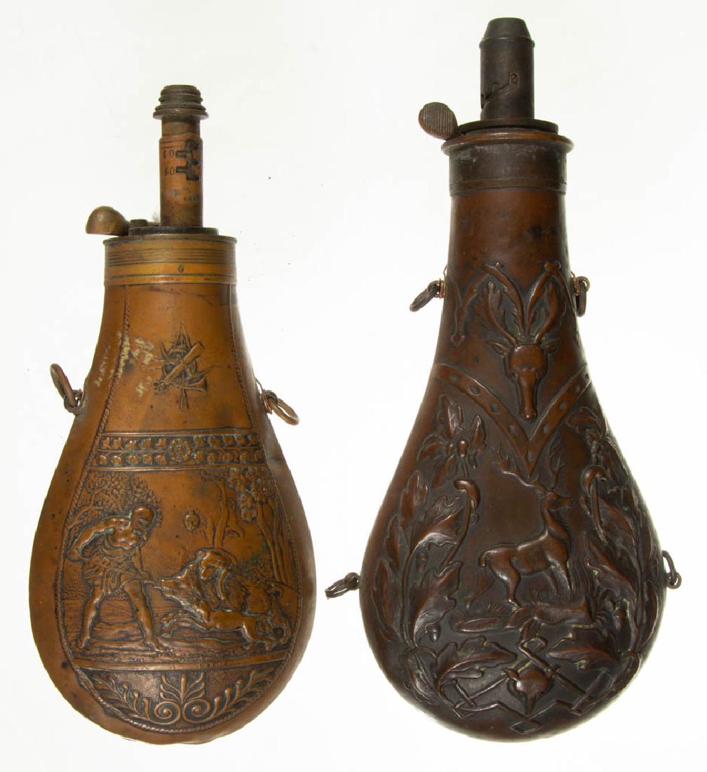 ASSORTED BRASS POWDER FLASKS, LOT OF TWO: ASSORTED BRASS POWDER FLASKS, LOT OF TWO, with embossed decoration of a stag with wolf's head and semi-nude man hunting a boar with a lion in the background. Stag decoration is stamped but illegible. 