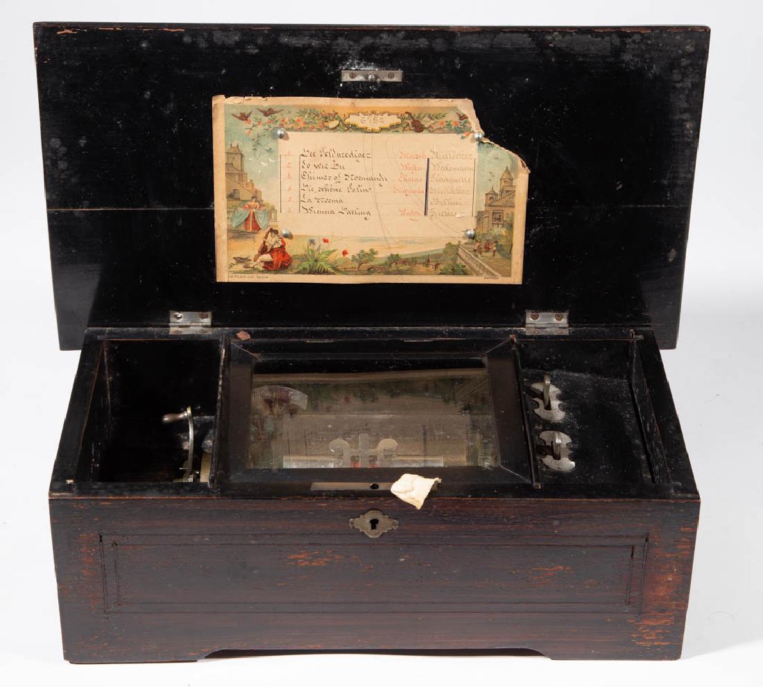 SWISS LEVER-WIND CYLINDER MUSIC BOX: SWISS LEVER-WIND CYLINDER MUSIC BOX, 5-inch cylinder playing six tunes on a 42-tooth steel comb, harp attachment, original tune card, inlaid mahogany case. Fourth quarter 19th century. 5 3/8" H, 14 3/