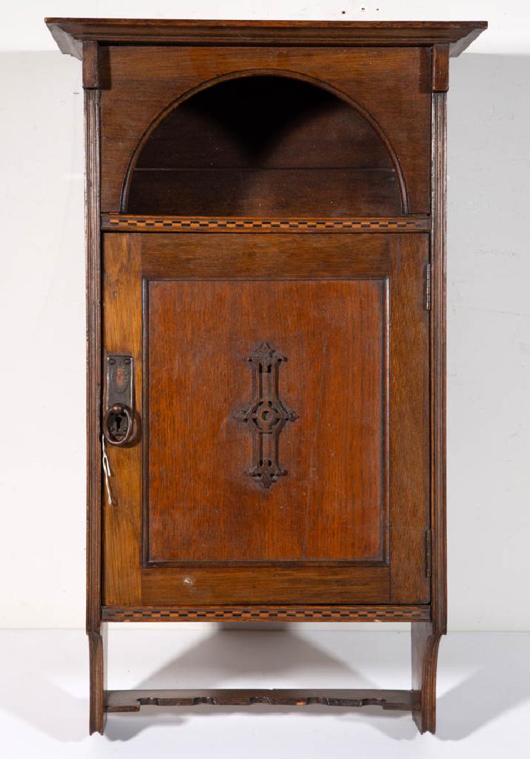 ENGLISH ARTS & CRAFTS INLAID OAK WALL HANGING CUPBOARD: ENGLISH ARTS & CRAFTS INLAID OAK WALL HANGING CUPBOARD, interior with a tag "Gratrix's 2 & 4 Hotel St. Bolton". Retains an old refinished surface with warm color. First quarter 20th century. 24" H, 14
