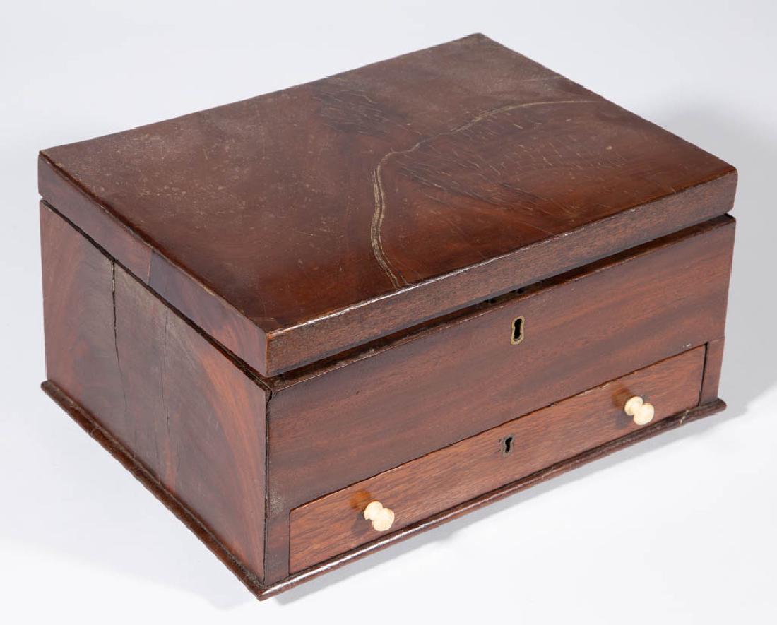 ENGLISH MAHOGANY SEWING / DRESSER BOX: ENGLISH MAHOGANY SEWING / DRESSER BOX, hinged lid, above full-length drawer with initials inscribed on the underside, raised on ball feet. First half 19th century. 5 3/4" H, 11" W, 8" D. Good overall 