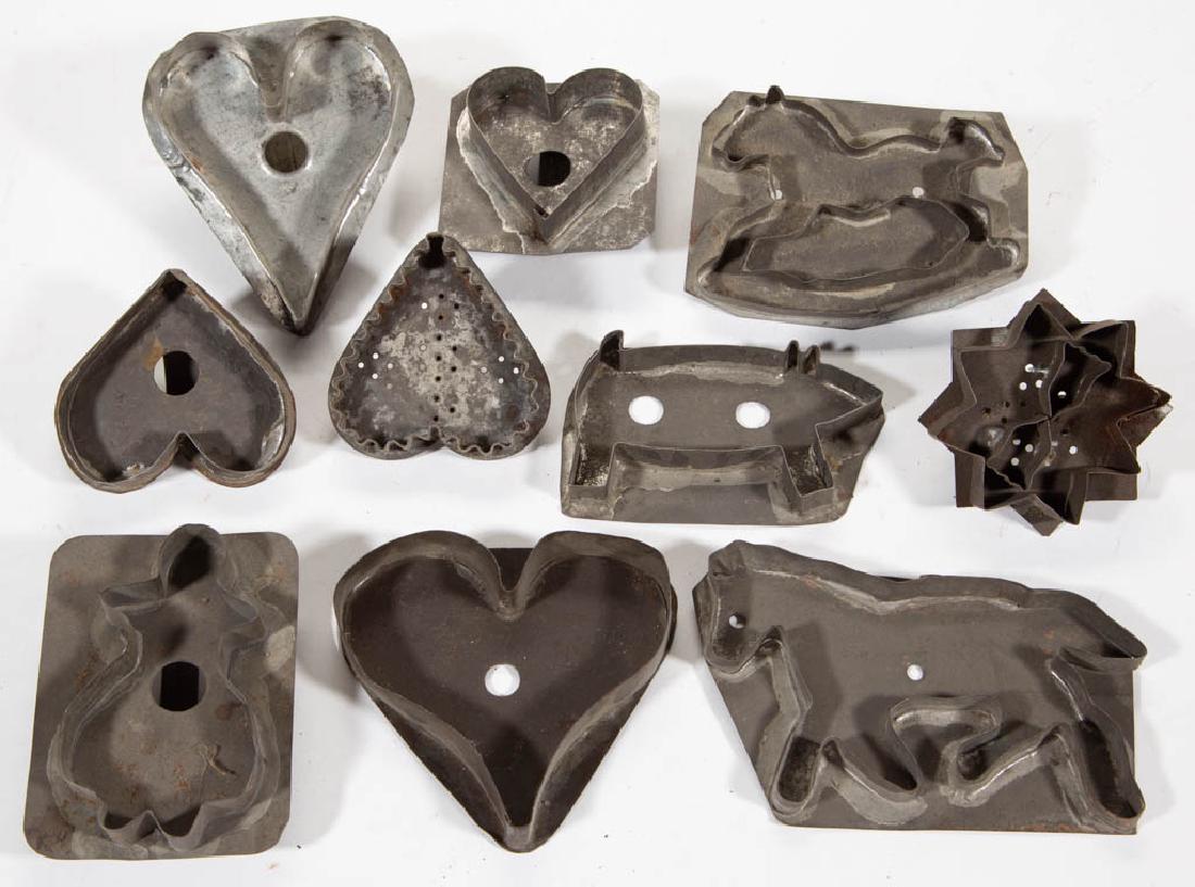 MID-ATLANTIC SHEET-IRON FIGURAL TIN COOKIE CUTTERS, LOT: MID-ATLANTIC SHEET-IRON FIGURAL TIN COOKIE CUTTERS, LOT OF TEN, comprising a pig, rocking horse, figure of a lady, a geometric figure with two tulips, horse, and five hearts, one made without a handle