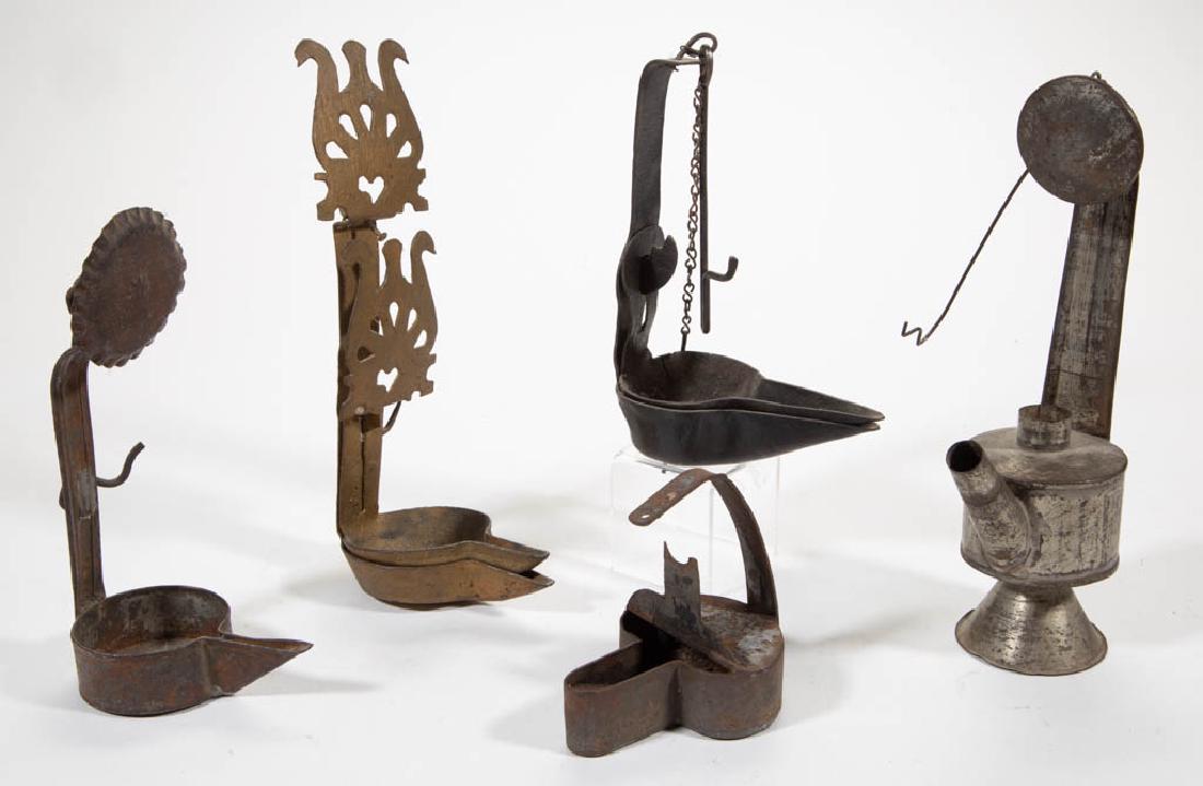ASSORTED SHEET-IRON LIGHTING ARTICLES, LOT OF FIVE: ASSORTED SHEET-IRON LIGHTING ARTICLES, LOT OF FIVE, comprising two double-chamber and a single-chamber crusies, one example with stylized scroll ornamentation back and later gold paint; a betty lamp, 
