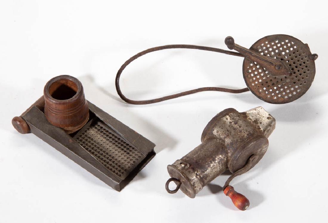 ASSORTED TIN / SHEET-IRON NUTMEG GRATERS, LOT OF THREE: ASSORTED TIN / SHEET-IRON NUTMEG GRATERS, LOT OF THREE, comprising two hand-crack example with one stamped "MTI Co" on both sides, and a sliding mechanism example. Fourth quarter 19th century. 4" to 7