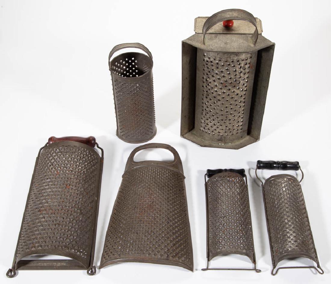 ASSORTED SHEET-IRON / TIN GRATERS, LOT OF SIX: ASSORTED SHEET-IRON / TIN GRATERS, LOT OF SIX, comprising a strap-handle with pull-out drawer grater, circle example with three sizes of holes, three with wooden handles, and a one-piece example. Four