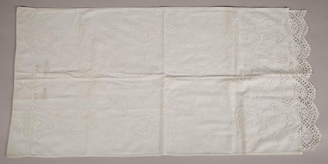SIGNED AND DATED PENNSYLVANIA WHITEWORK BOLSTER COVER: SIGNED AND DATED PENNSYLVANIA WHITEWORK BOLSTER COVER, all hand-stitched, elaborate embroidery including candlewick and open-work, inked "Maria Weis / 1860" along closed end. Circa 1860. 20" x 40". Ex
