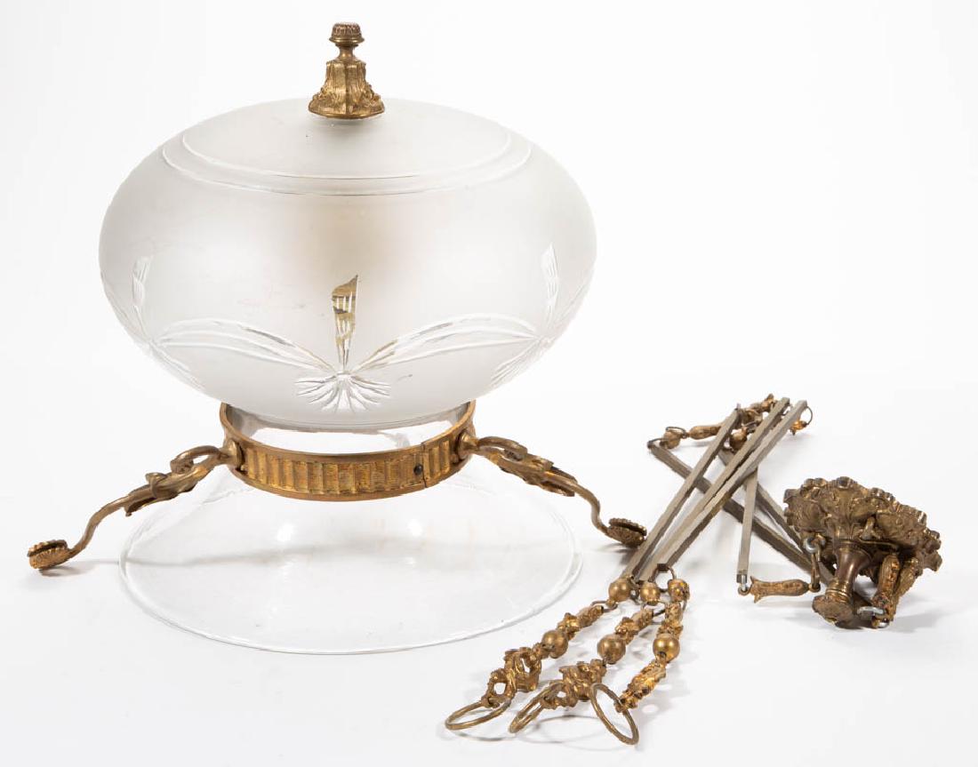 FEDERAL-STYLE BLOWN AND ENGRAVED GLASS HANGING LAMP: FEDERAL-STYLE BLOWN AND ENGRAVED GLASS HANGING LAMP, with gilt-brass mounts, electrified interior burner, supported on three chains hooked to the ceiling plate. First quarter 20th century. 55" HOA, 12