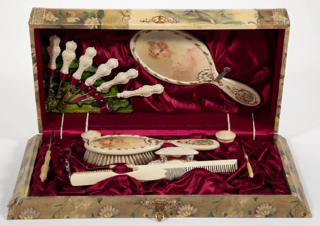 VICTORIAN CELLULOID DRESSER SET: VICTORIAN CELLULOID DRESSER SET, comprising a hinged lid box depicting an elegant young lady, fitted interior retaining 18 likely original accessories. Late 19th/early 20th century. Box 3 1/2" H, 17" 