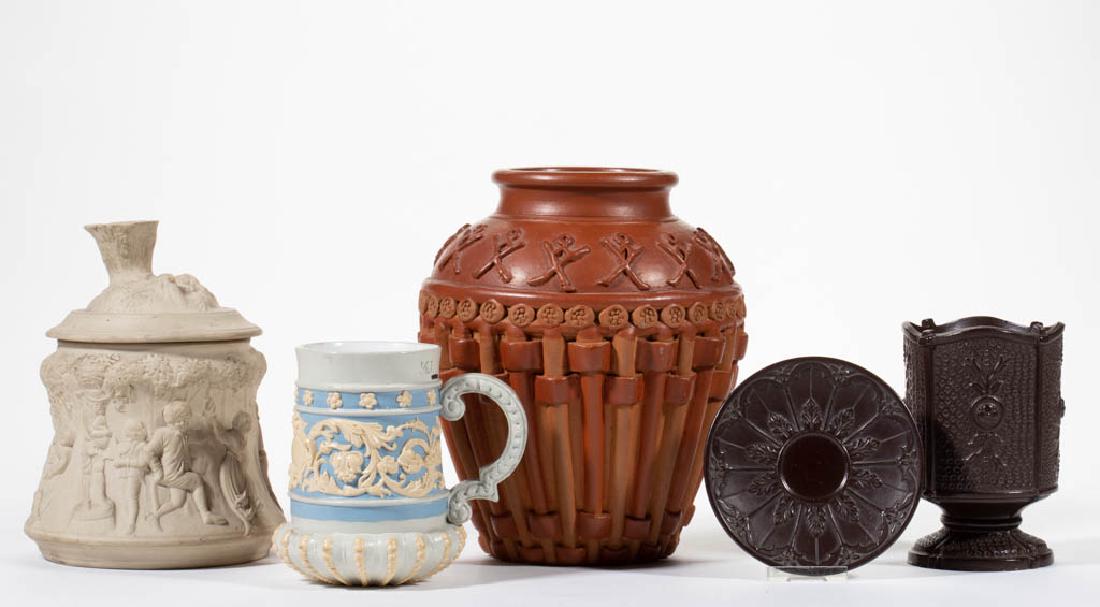 CONTINENTAL RELIEF MOLDED CERAMIC ARTICLES, LOT OF FIVE: CONTINENTAL RELIEF MOLDED CERAMIC ARTICLES, LOT OF FIVE, including a goblet and saucer with dark brown glaze, floral motif on five panels, and impressed "WS & S" and attributed to Wilhelm Schiller & S