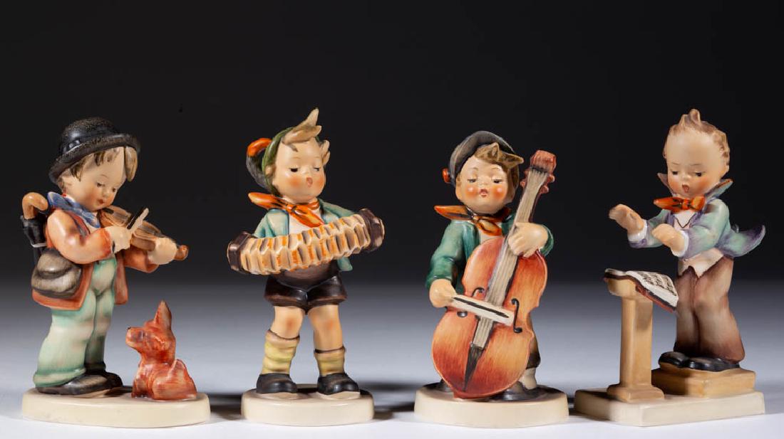 GERMAN GOEBEL HUMMEL CERAMIC FIGURES, LOT OF FOUR: GERMAN GOEBEL HUMMEL CERAMIC FIGURES, LOT OF FOUR, comprising boys playing various instruments including violin (#4), cello (#186), and accordion (#185), having original sticker, and a director with m
