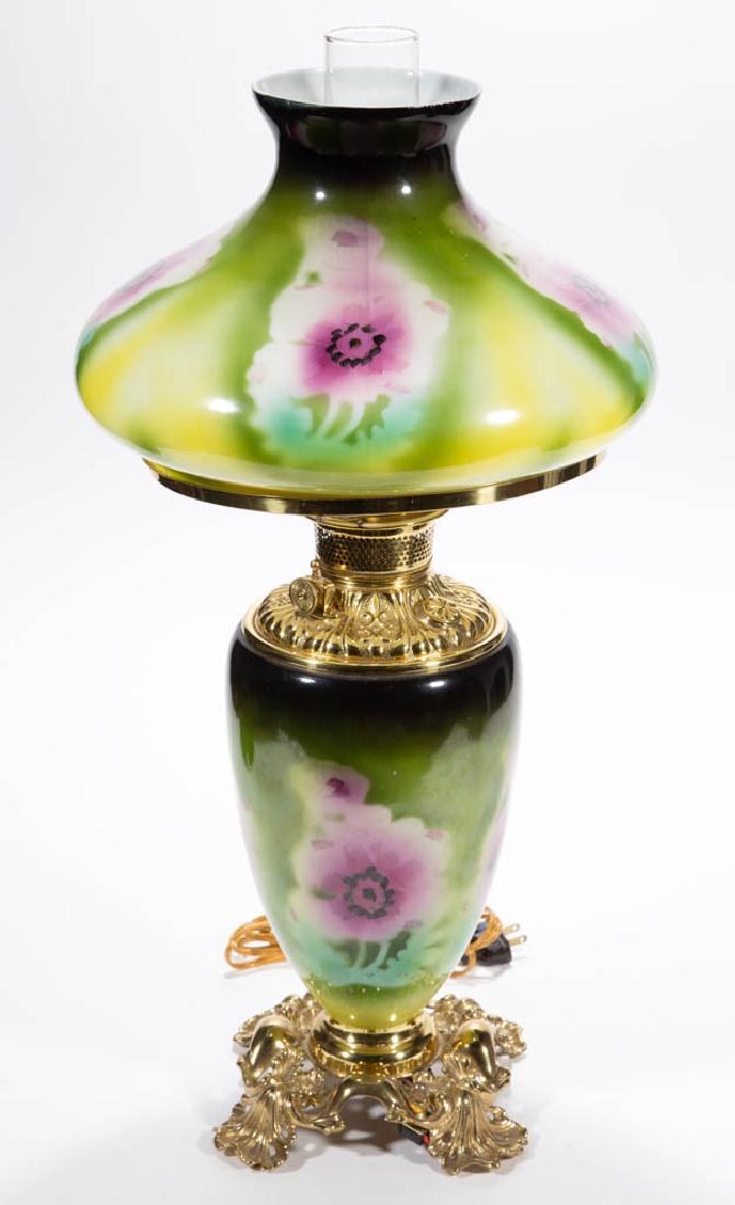 VICTORIAN ENAMEL-DECORATED PARLOR / GONE WITH THE WIND: VICTORIAN ENAMEL-DECORATED PARLOR / GONE WITH THE WIND LAMP, opaque white with dark to medium green ground, polychrome pansy decoration, matching decorated umbrella-form shade; elongated-form font vas