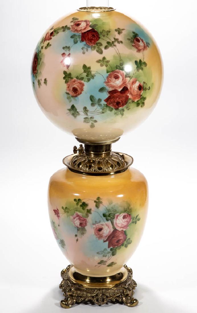 FOSTORIA ENAMEL-DECORATED PARLOR / GONE WITH THE WIND: FOSTORIA ENAMEL-DECORATED PARLOR / GONE WITH THE WIND LAMP, opaque white with yellow ground and pink rose polychrome stencil decoration, matching decorated large ball-form shade with brass heat ring; 