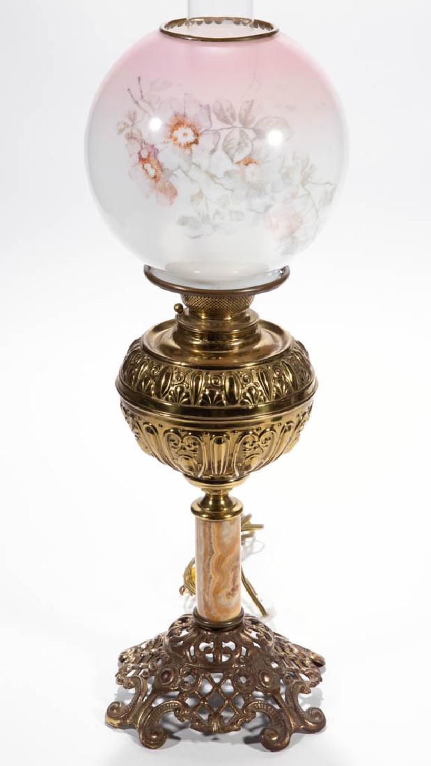 VICTORIAN CAST-METAL AND BRASS BANQUET LAMP: VICTORIAN CAST-METAL AND BRASS BANQUET LAMP, opaque white ball-form shade with pale pink stain and polychrome stencil decoration, brass heat ring, brass globular-form font with stamped ornamentation o