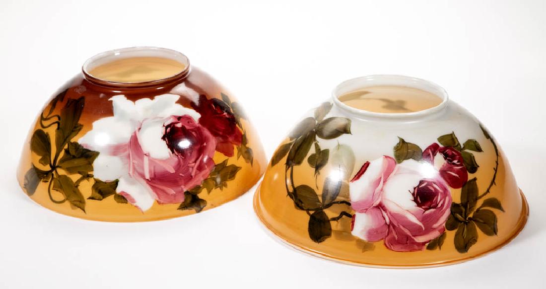 ENAMEL-DECORATED OPAL SHADES, LOT OF TWO: ENAMEL-DECORATED OPAL SHADES, LOT OF TWO, brown and butterscotch stain and hand-painted polychrome rose decoration, umbrella form, ringed top. Fourth quarter 19th/early 20th century. 6" H, 14" D and 1