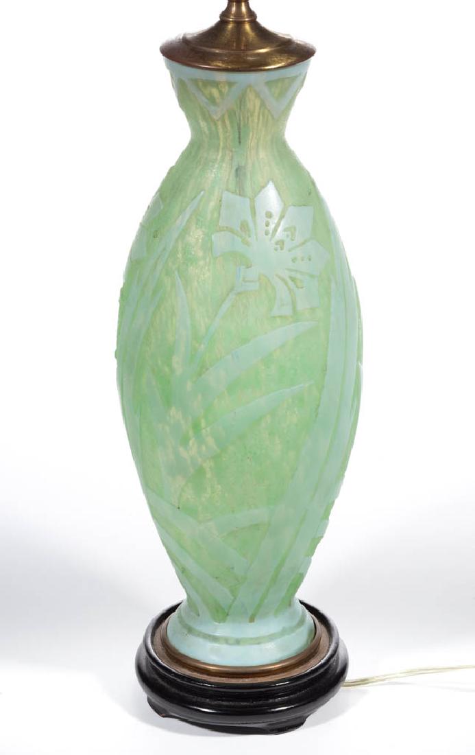 STEUBEN DAPHNE ACID CUT-BACK / CAMEO ART GLASS TABLE: STEUBEN DAPHNE ACID CUT-BACK / CAMEO ART GLASS TABLE LAMP, Opal over Green Cintra, shape 6933, Daphne decoration with brass mounts, fitted onto a ebonized wooden base. Steuben Glass Works. Circa 1925.