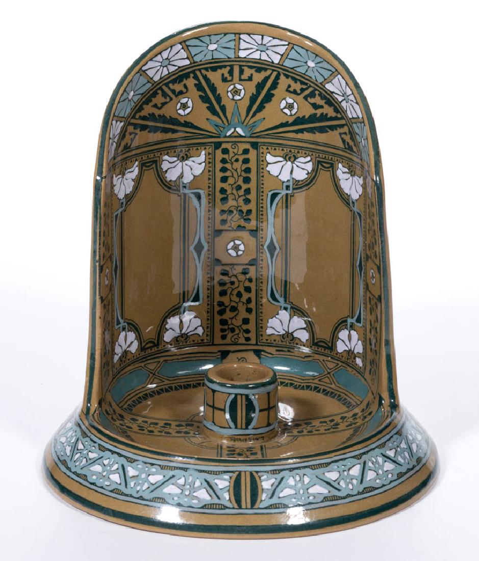 AMERICAN BUFFALO POTTERY EMERALD DELDARE CERAMIC: AMERICAN BUFFALO POTTERY EMERALD DELDARE CERAMIC SHIELD-BACK CANDLE HOLDER, with Art Nouveau-style floral decoration and hand grip on back of shield, signed "L. Streissel" on base of candlestick holde