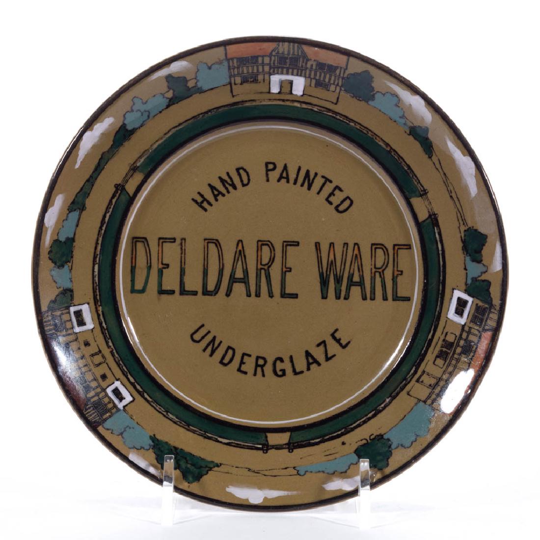 AMERICAN BUFFALO POTTERY DELDARE SALESMAN SAMPLE: AMERICAN BUFFALO POTTERY DELDARE SALESMAN SAMPLE CERAMIC PLATE, having black transfer "HAND PAINTED / DELDARE WARE / UNDERGLAZE" on front with polychrome hand-painted colonial house border. Black prin