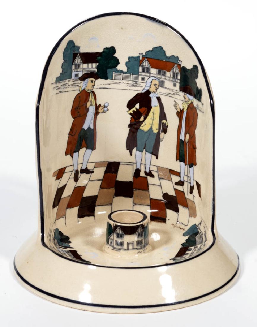 AMERICAN BUFFALO POTTERY DELDARE CERAMIC SHIELD-BACK: AMERICAN BUFFALO POTTERY DELDARE CERAMIC SHIELD-BACK CANDLE HOLDER, having a cream ground with three men in colonial dress on back of interior with period houses on interior base and candle holder, wi