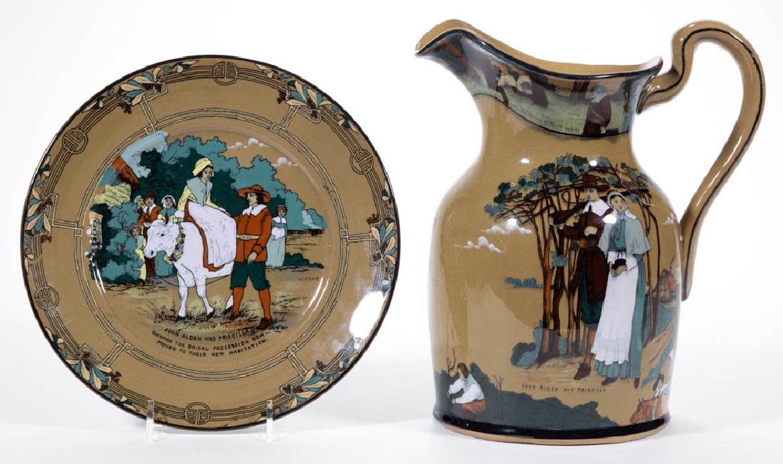 AMERICAN BUFFALO POTTERY DELDARE PILGRIM CERAMIC: AMERICAN BUFFALO POTTERY DELDARE PILGRIM CERAMIC PITCHER AND PLATE, LOT OF TWO, comprising a pitcher depicting various images including a brooding Miles Standish, John Alden and Priscilla, and the May
