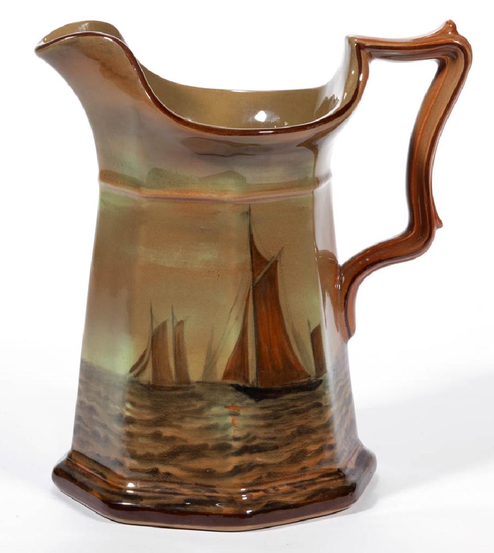 AMERICAN BUFFALO POTTERY ABINO WARE CERAMIC PITCHER: AMERICAN BUFFALO POTTERY ABINO WARE CERAMIC PITCHER, having an octagonal, panelled body with rust-colored hand-painted sailboat scene, signed "W. Foster" on bottom. Hand-brushed mark "ABINO WARE / BUF