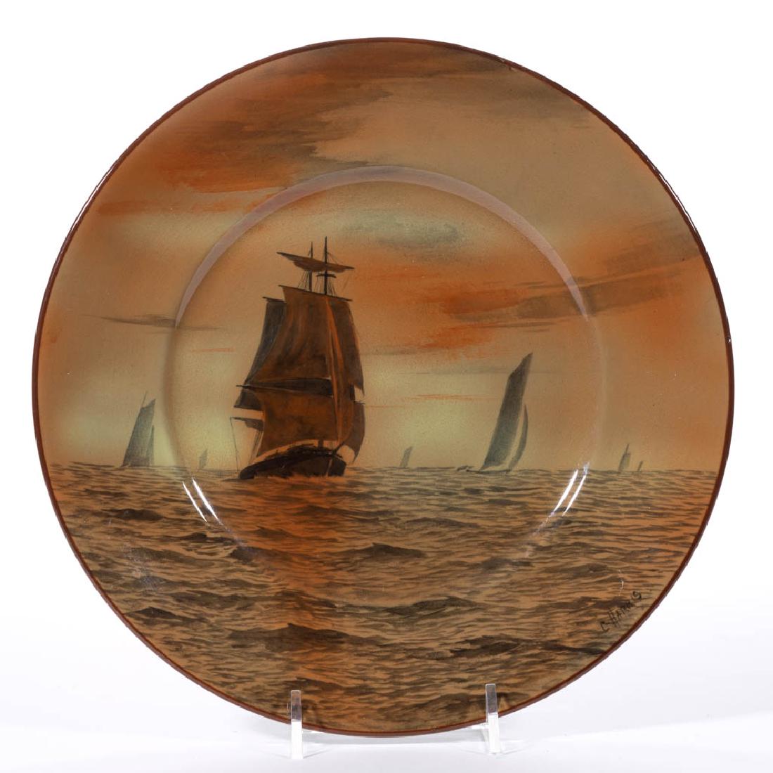 AMERICAN BUFFALO POTTERY ABINO WARE CERAMIC PLATE: AMERICAN BUFFALO POTTERY ABINO WARE CERAMIC PLATE, with rust-colored hand-painted scene of sailboats and a tall-masted ship in the foreground, signed "C. Harris" on lower right bottom. Hand-brushed ma