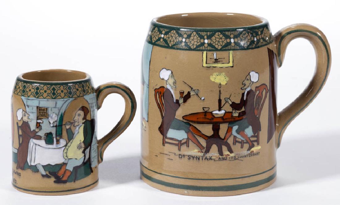 AMERICAN BUFFALO POTTERY EMERALD DELDARE DR. SYNTAX: AMERICAN BUFFALO POTTERY EMERALD DELDARE DR. SYNTAX CERAMIC MUGS, LOT OF TWO, comprising one with scene "Dr. Syntax And His Counterpart", signed "M.", and one with scene "I Give The Law To That Are Ow
