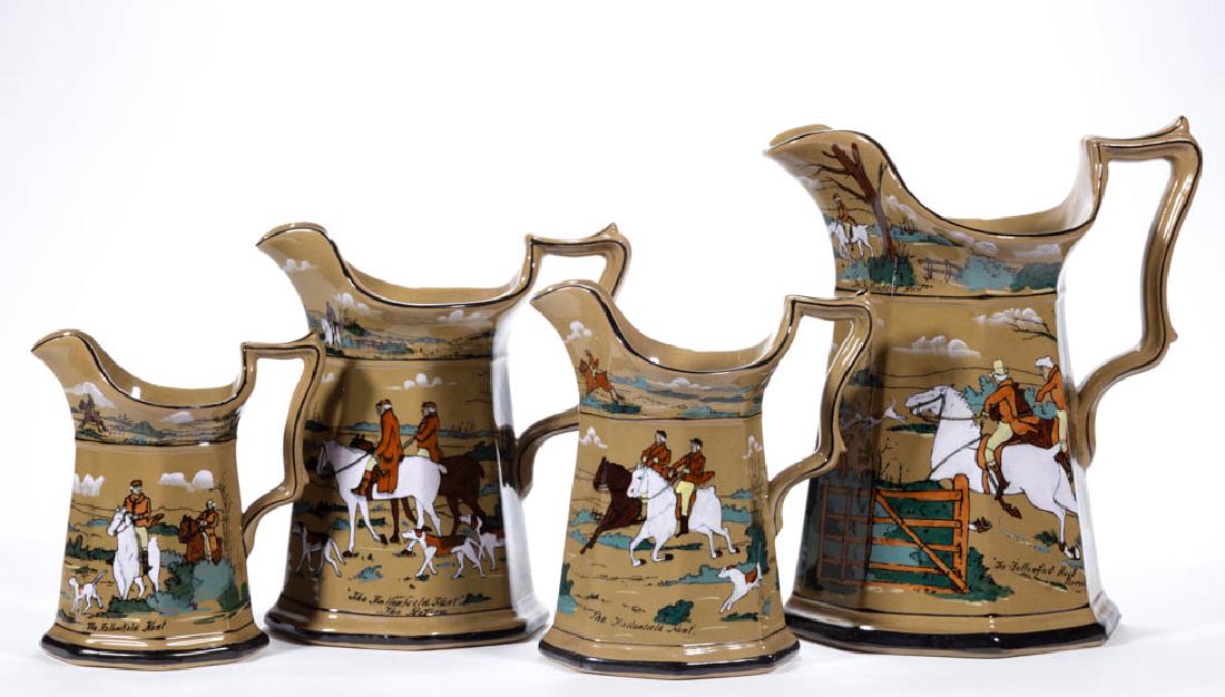 AMERICAN BUFFALO POTTERY DELDARE "THE FALLOWFIELD HUNT": AMERICAN BUFFALO POTTERY DELDARE "THE FALLOWFIELD HUNT" CERAMIC PITCHERS, LOT OF FOUR, with octagonal, panelled bodies having scenes including "Breaking Cover" and "The Return", each on olive ground, 