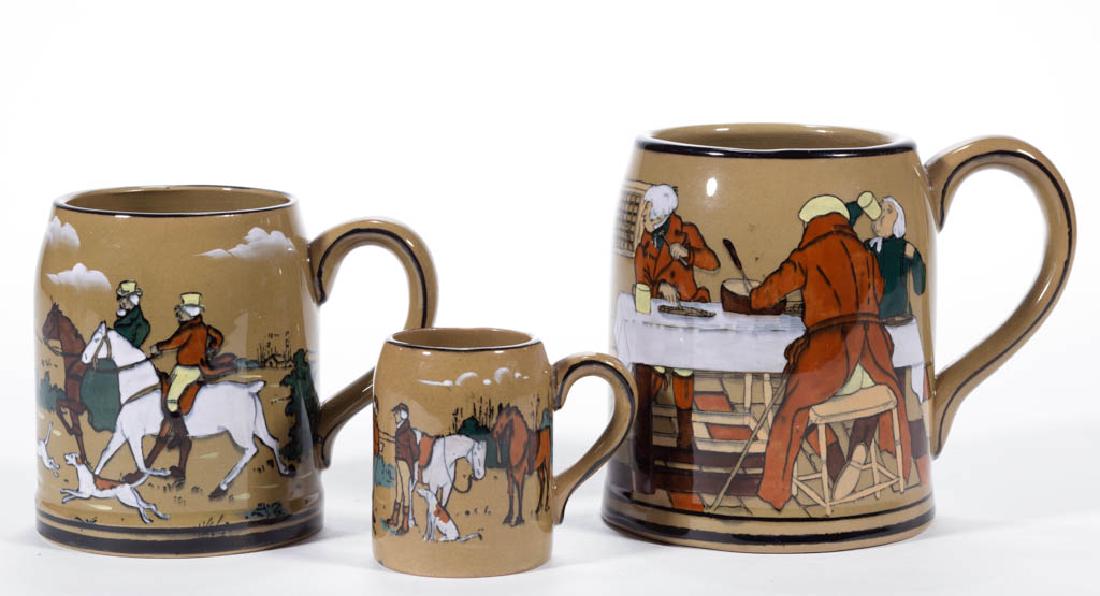 AMERICAN BUFFALO POTTERY DELDARE "THE FALLOWFIELD HUNT": AMERICAN BUFFALO POTTERY DELDARE "THE FALLOWFIELD HUNT" CERAMIC MUGS, LOT OF THREE, having scenes "At the Three Pigeons", "Breaking Cover", and "The Fallowfield Hunt", with signatures including "H. Fo