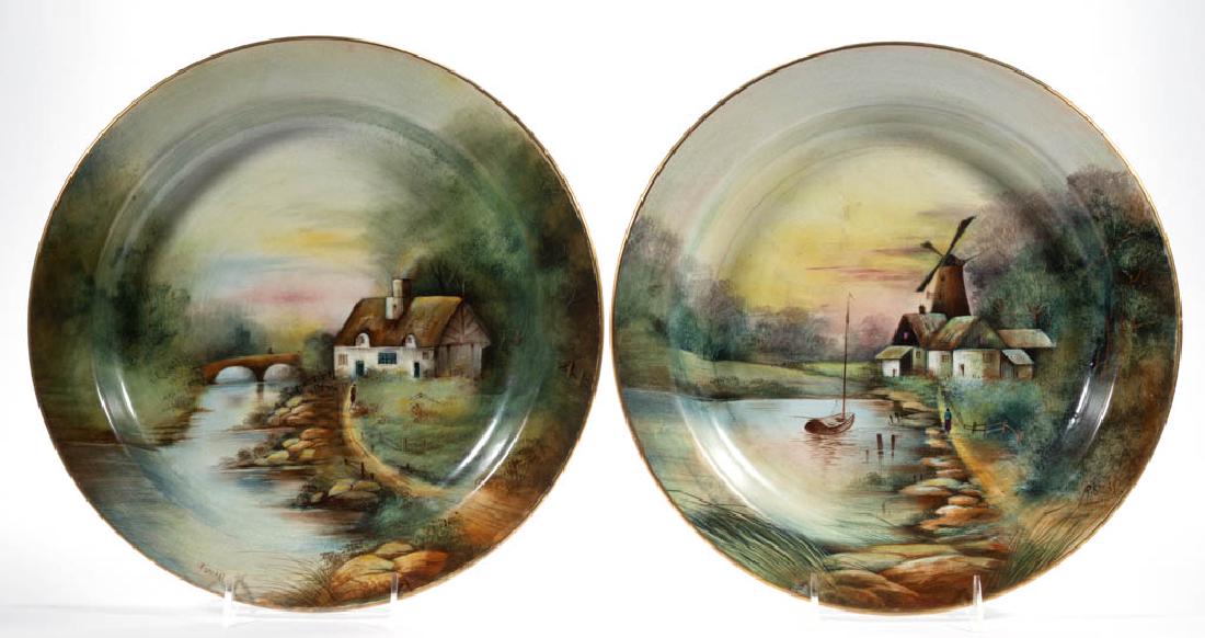 AMERICAN BUFFALO POTTERY RALPH STUART HAND-PAINTED: AMERICAN BUFFALO POTTERY RALPH STUART HAND-PAINTED CERAMIC PLAQUES / CHARGERS, LOT OF TWO, comprising one with quaint cottages, boat, and windmill scene and one having charming white cottage beside an