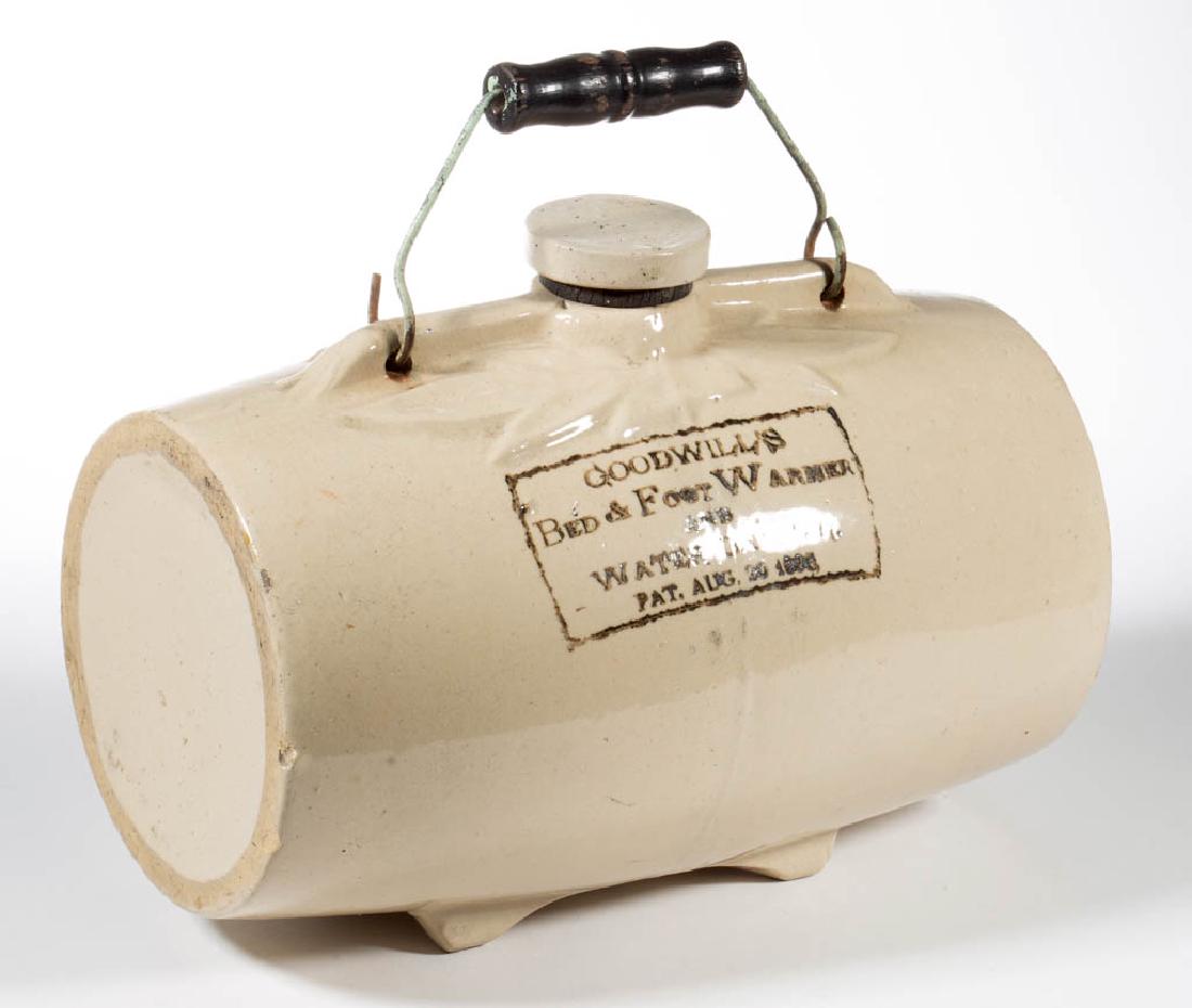 AMERICAN STONEWARE GOODWILL'S BED AND FOOT WARMER /: AMERICAN STONEWARE GOODWILL'S BED AND FOOT WARMER / WATER CARRIER, barrel-shaped, having molded leaf design on top with four feet on base, having "GOODWILL'S / BED & FOOT WARMER / AND / WATER CARRIER 
