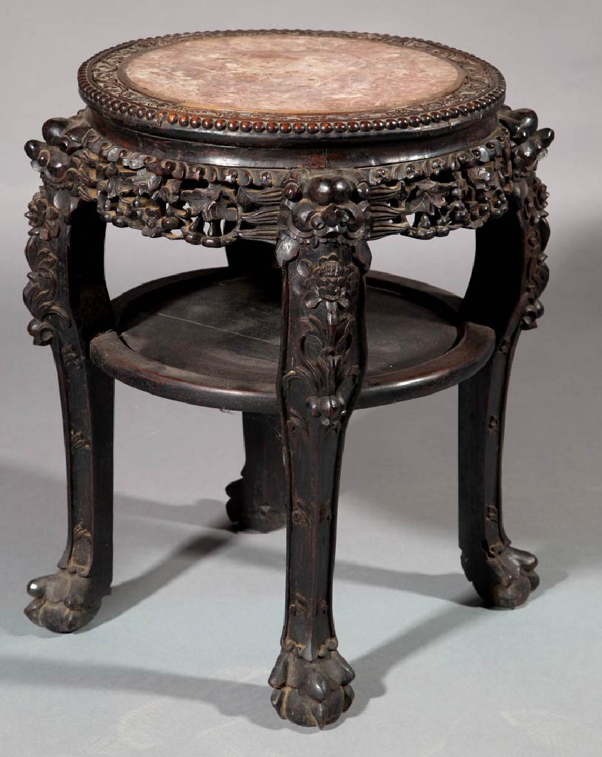 CHINESE CARVED WOOD AND MARBLE-TOP TABLE: CHINESE CARVED WOOD AND MARBLE-TOP TABLE, rosewood or related, with red-variegated marble insert, carvings of four foo dogs with legs terminating in paw feet. Retains an old surface with rich color. F