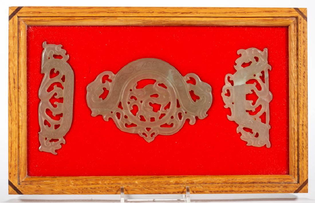 CHINESE CARVED JADE / NEPHRITE PLAQUES, LOT OF THREE: CHINESE CARVED JADE / NEPHRITE PLAQUES, LOT OF THREE, each having a pierced design with animals/mythological creature and etched scrolled design, largest piece with dragon-like figure and heads. Unmar