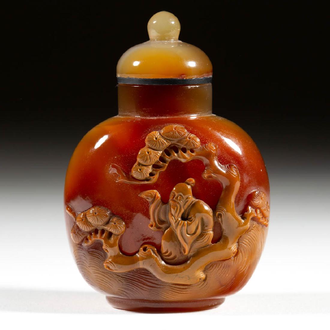 CHINESE CARVED AGATE SNUFF BOTTLE: CHINESE CARVED AGATE SNUFF BOTTLE, brown-toned stone bottle with relief carving of a scholar/sage figure sitting under a tree to one side, topped by a carved stone cap with spherical finial and interi
