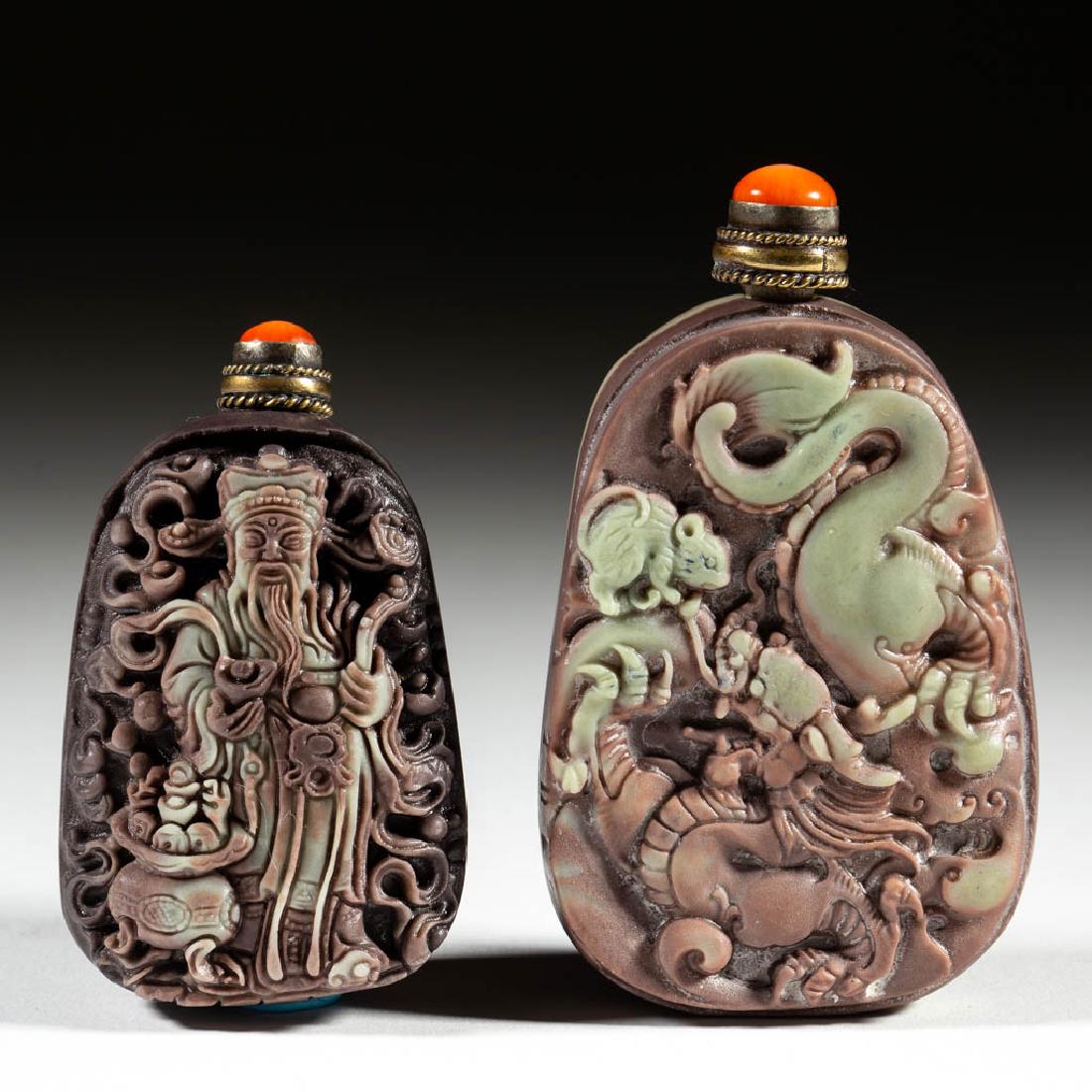CHINESE CARVED STONE SNUFF BOTTLES, LOT OF TWO: CHINESE CARVED STONE SNUFF BOTTLES, LOT OF TWO, each ovoid-form bottle made from a purple and green-toned banded stone, probably Duan/inkstone, with bas-relief carving to one side, topped by metal cap