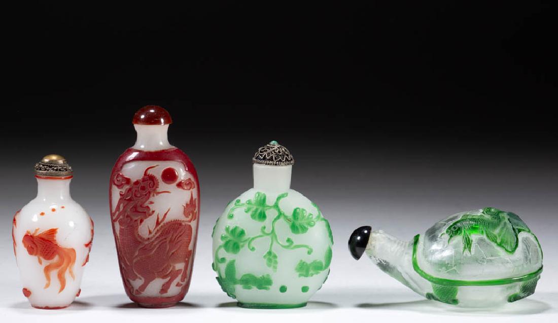 CHINESE CARVED PEKING CAMEO GLASS SNUFF BOTTLES, LOT OF: CHINESE CARVED PEKING CAMEO GLASS SNUFF BOTTLES, LOT OF FOUR, comprising one green to colorless turtle-shaped example with fish and lotus leaf design on shell, one green to white example with squirrel