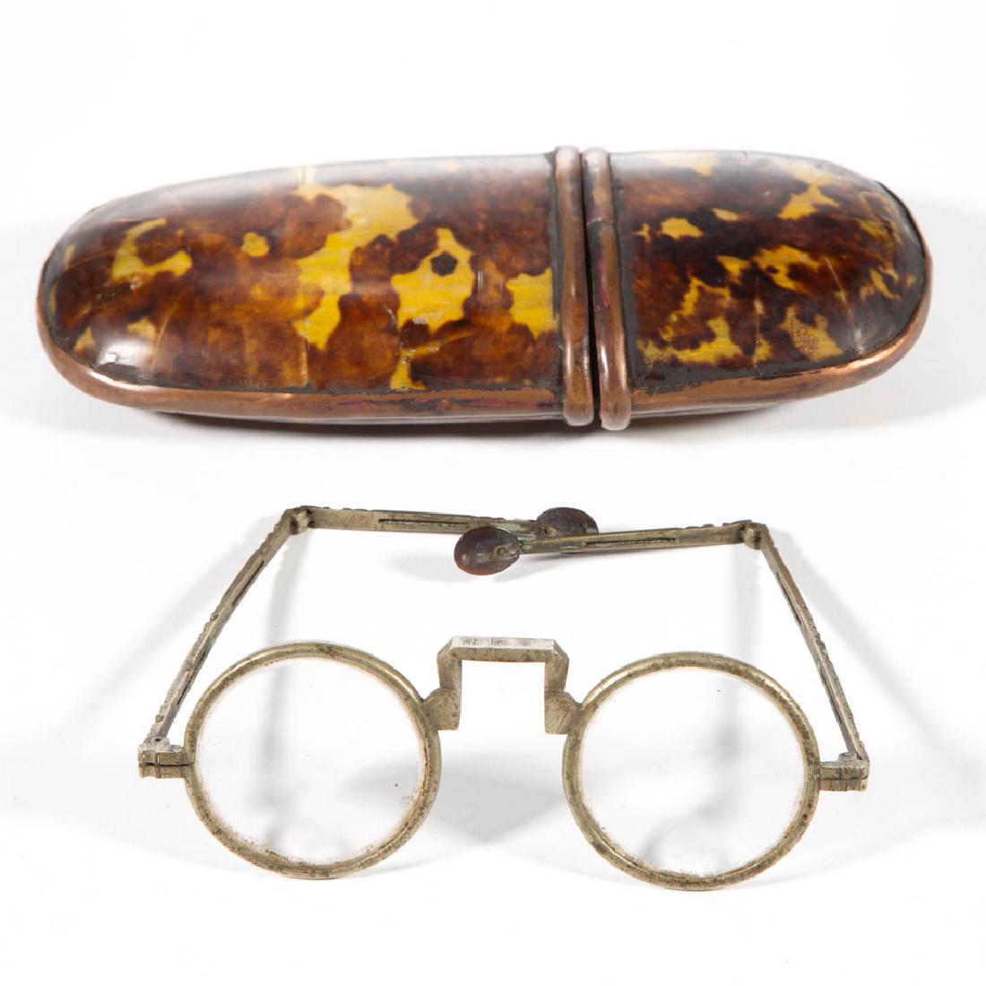 CHINESE EYEGLASSES AND CASE: CHINESE EYEGLASSES AND CASE, case having a shell-like cover and copper-edge, glasses with brass folding temples. Second half 19th/early 20th century. 7" L case.Very good overall condition with minor l