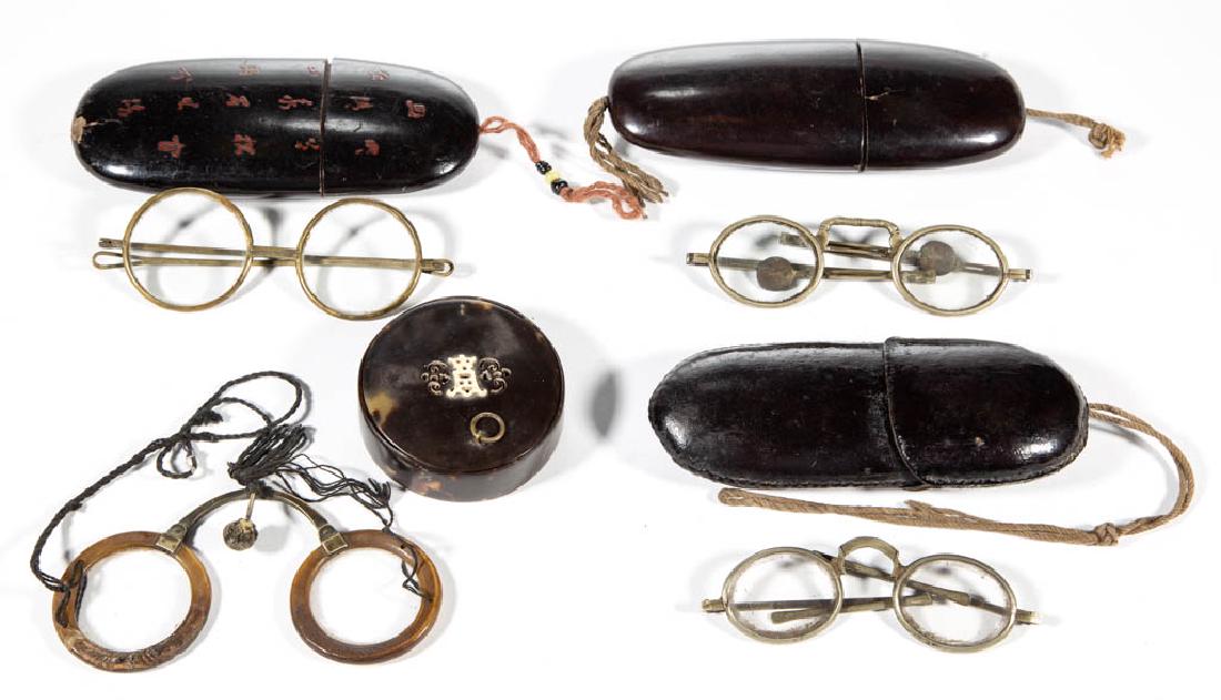 CHINESE EYEGLASSES AND CASES, LOT OF FOUR: CHINESE EYEGLASSES AND CASES, LOT OF FOUR, including a shell-like case with bone inlay on top and horn-rimmed folding glasses. Second half 19th/early 20th century. 2 3/4" to 6" L case.Shell-like case